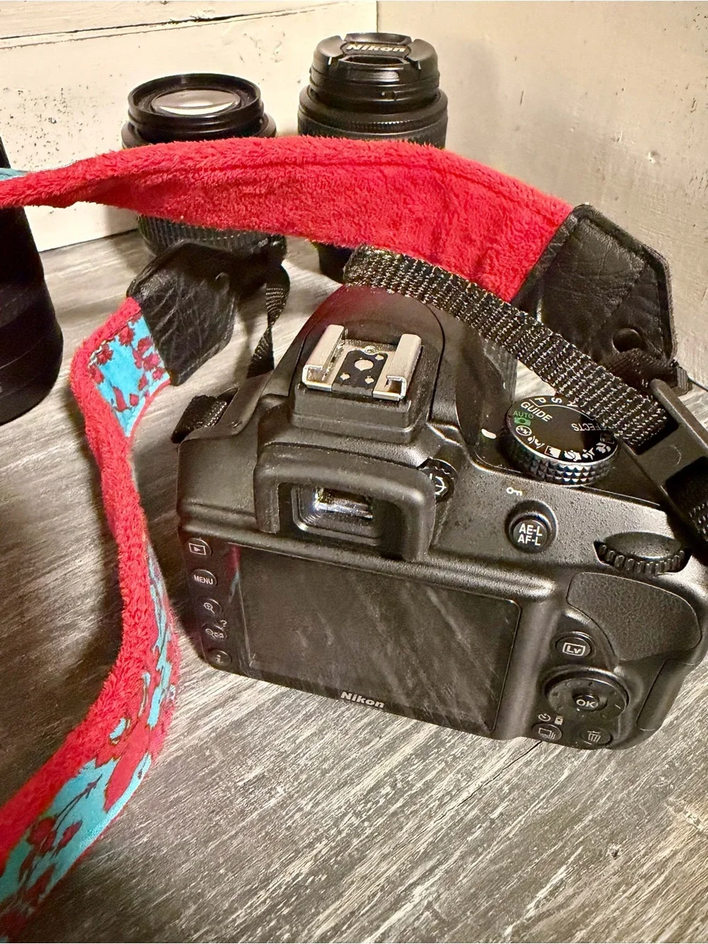 Nikon Camera Kit with Black Lenses and Red Strap